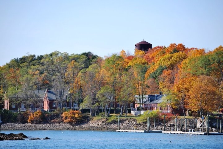 a small boat in a body of water with a city in the background