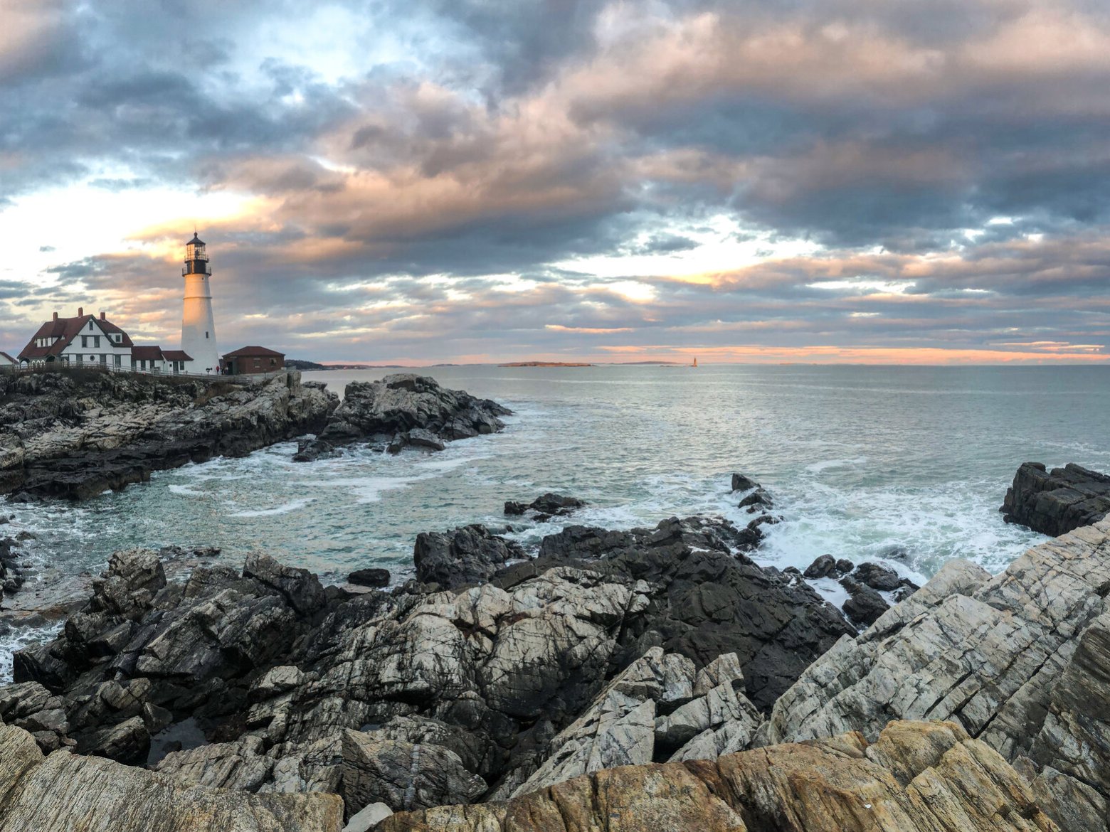 a rocky island in the middle of a body of water