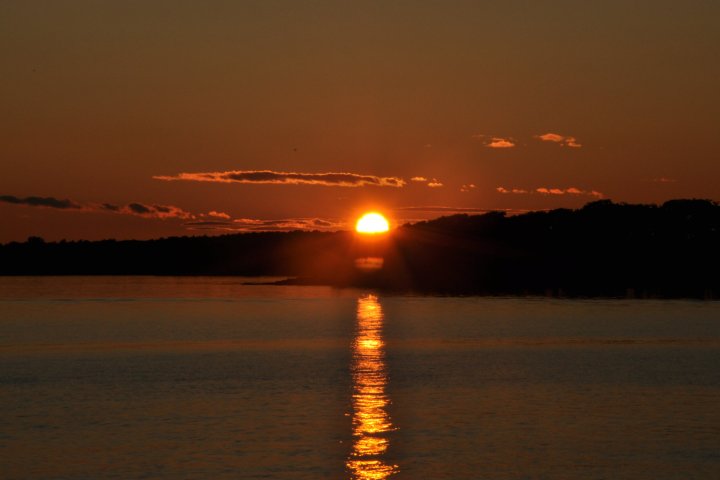 a sunset over a body of water