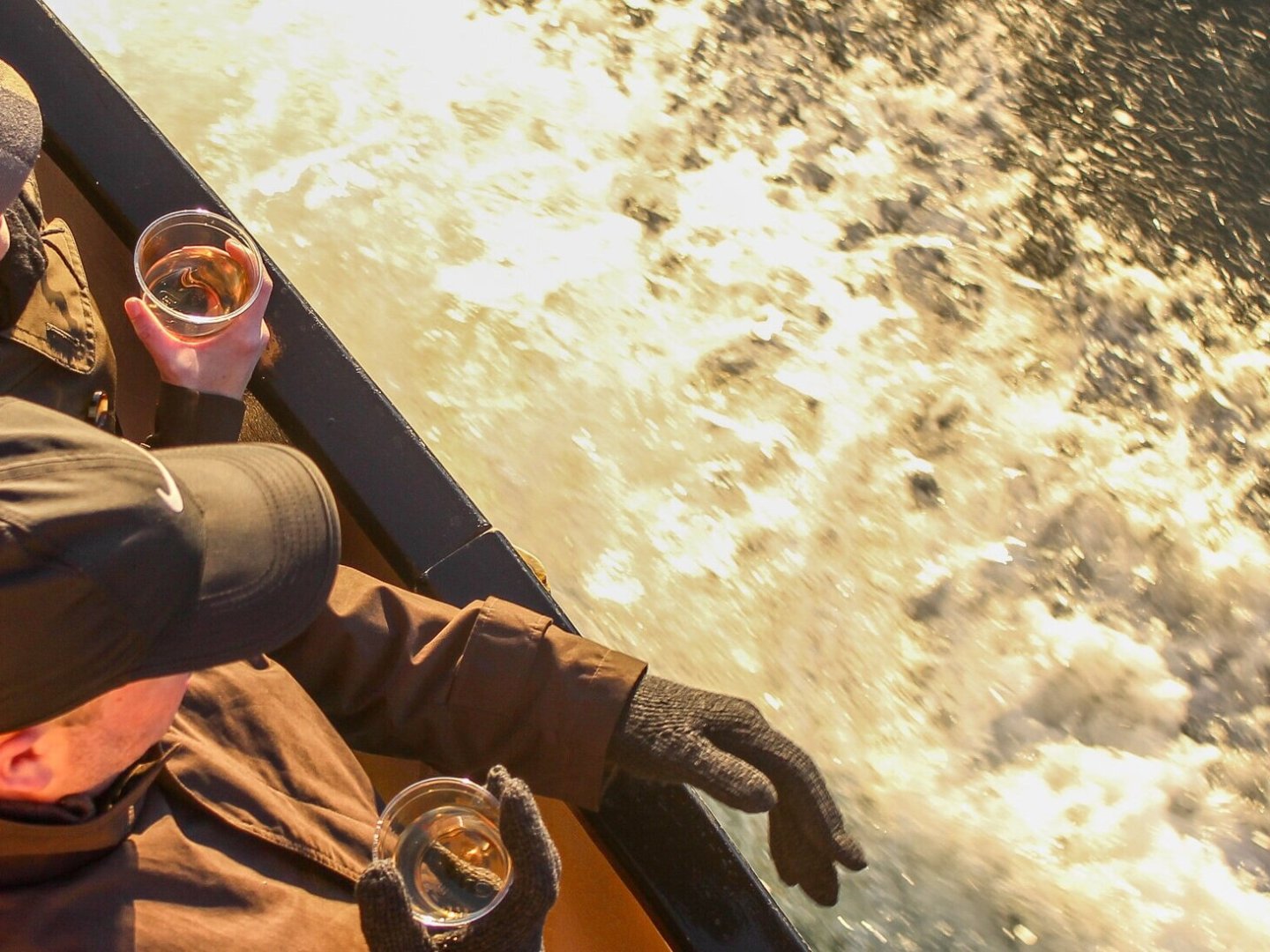a man wearing a hat and sunglasses posing for the camera