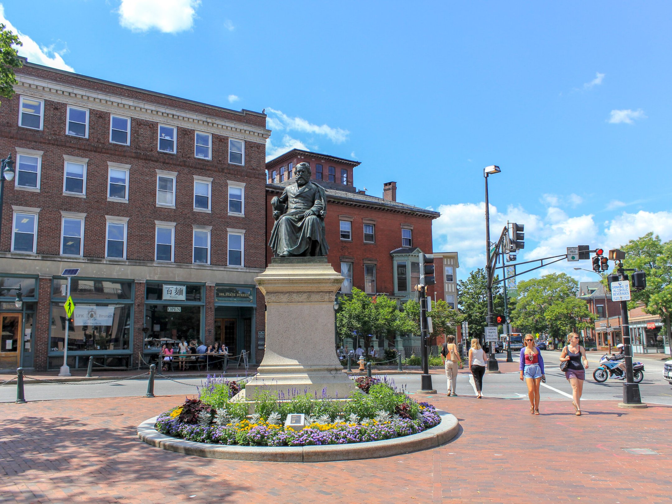 a group of people walking down a street next to a building