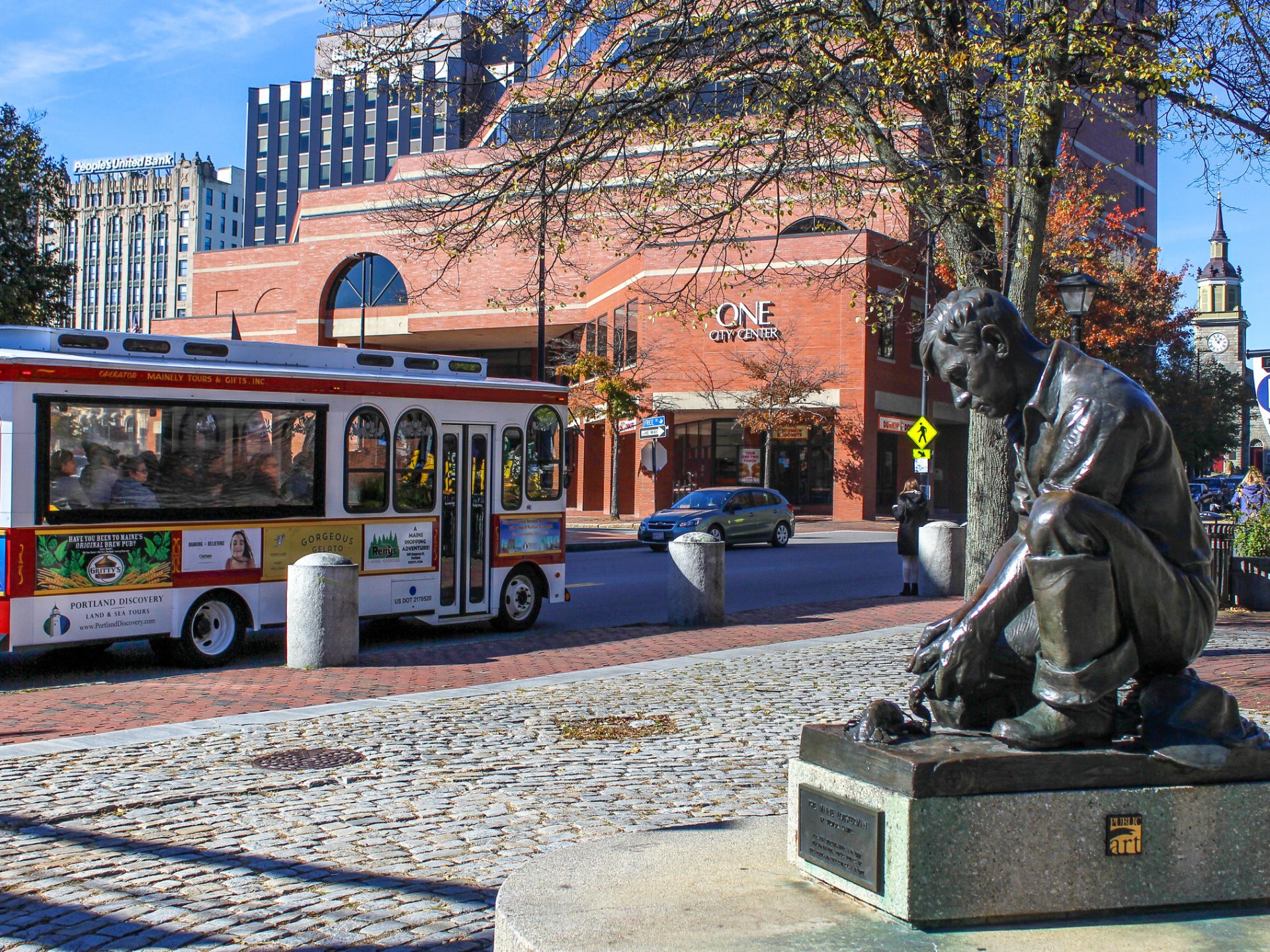 a group of people sitting at a bus stop