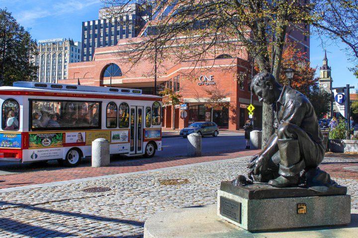 a group of people sitting at a bus stop