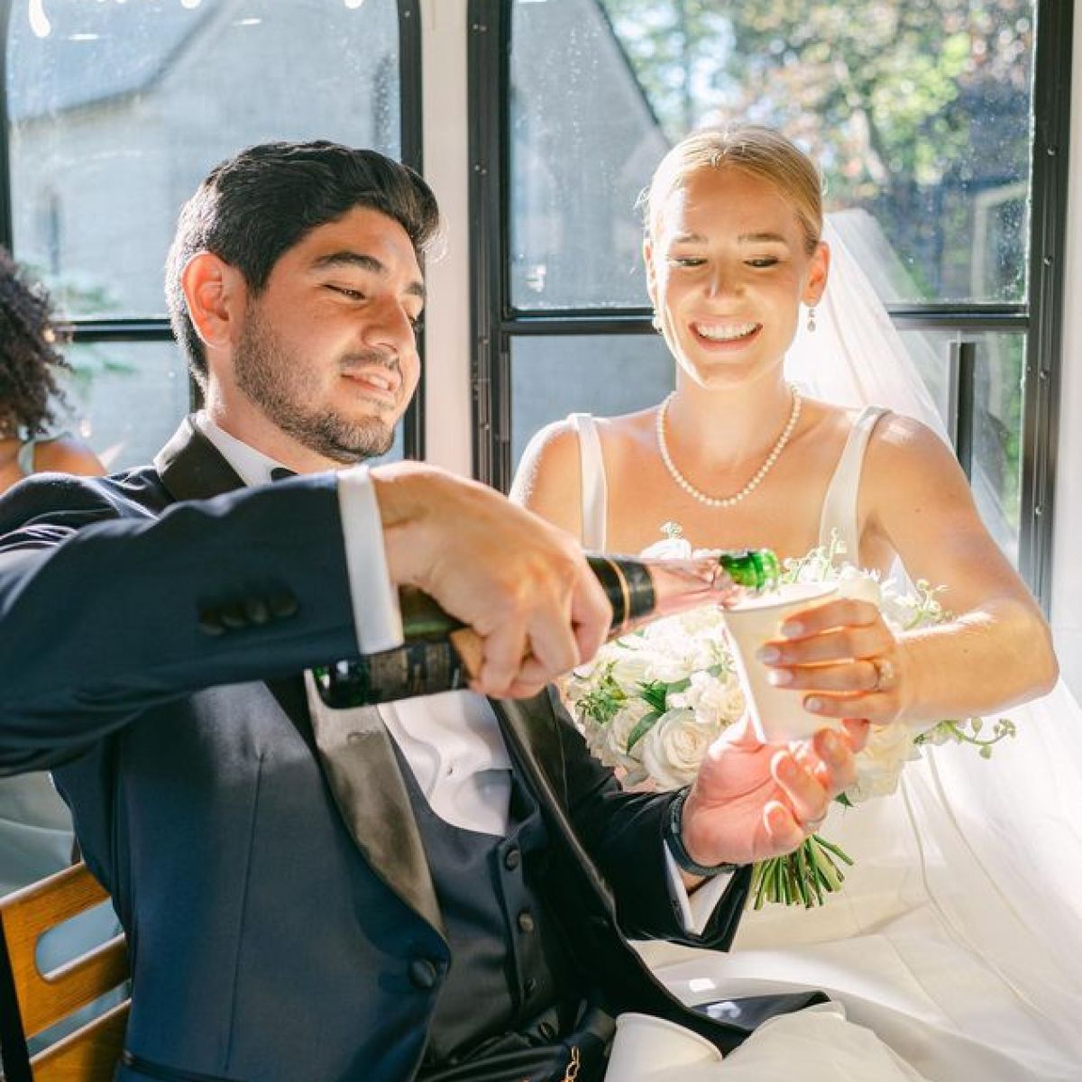 a man and a woman sitting at a table in front of a window