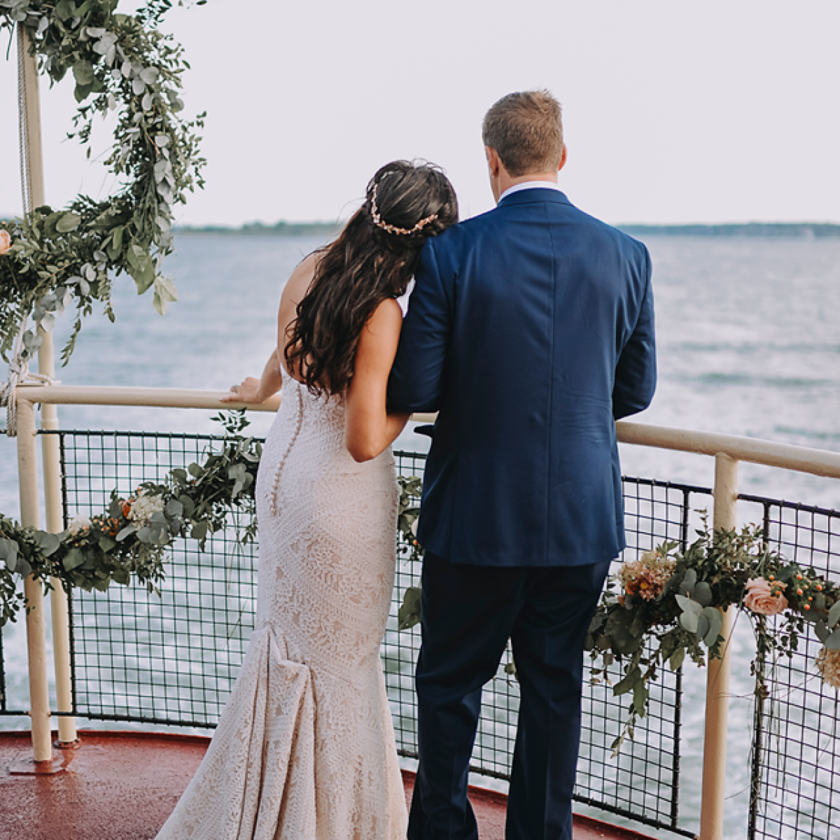 a man and a woman standing in front of water
